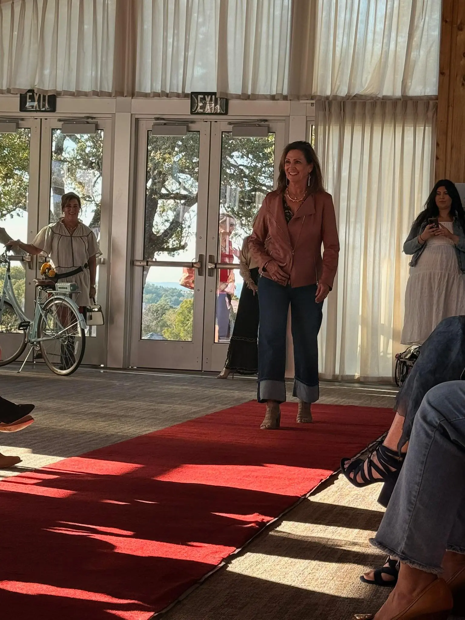 Smiling woman walking down indoor red carpet