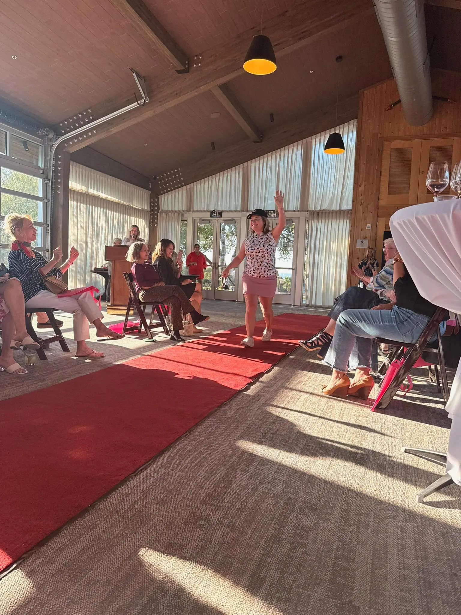 Person walking down indoor runway with audience