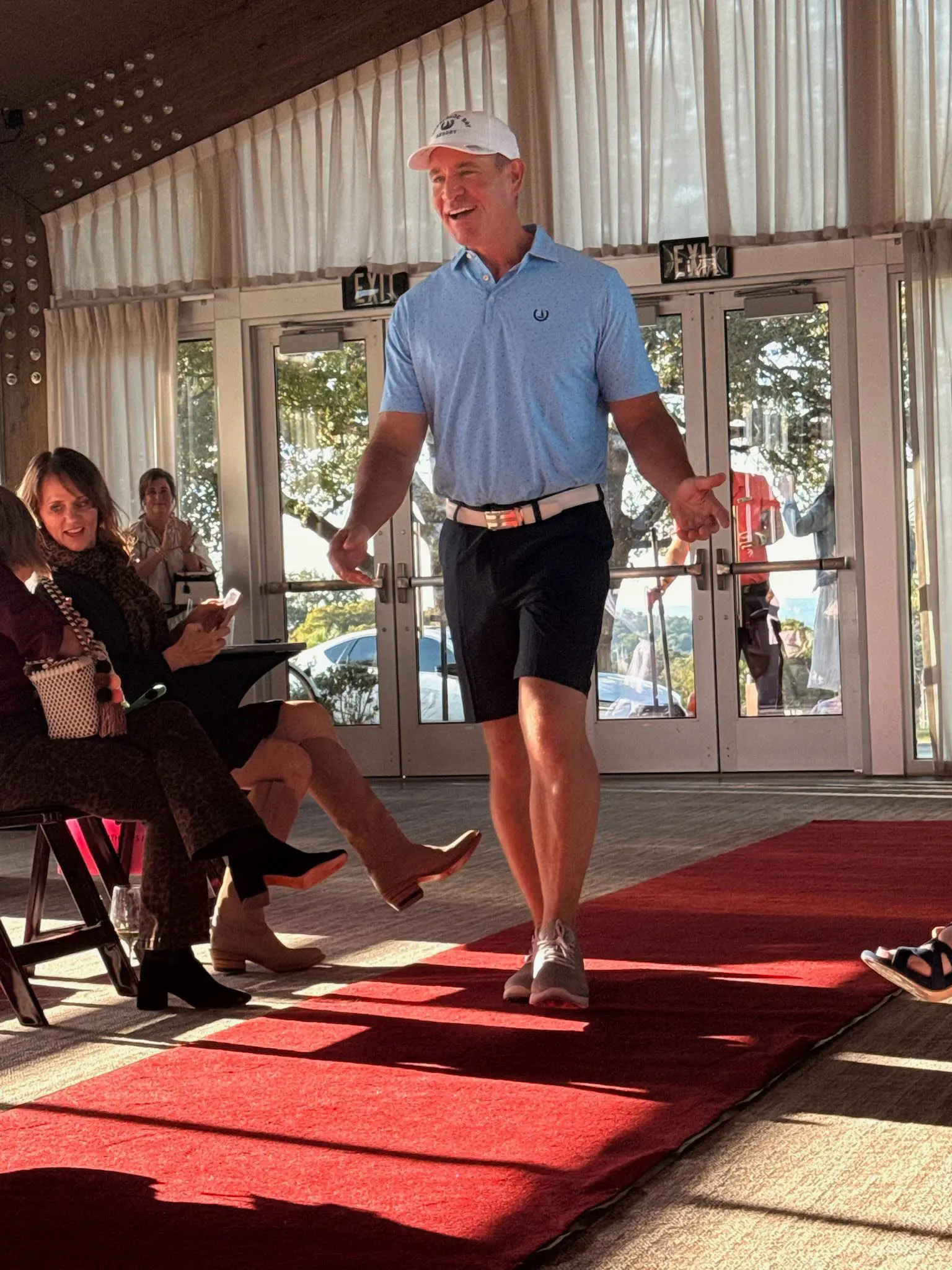 Man modeling golf outfit on red runway