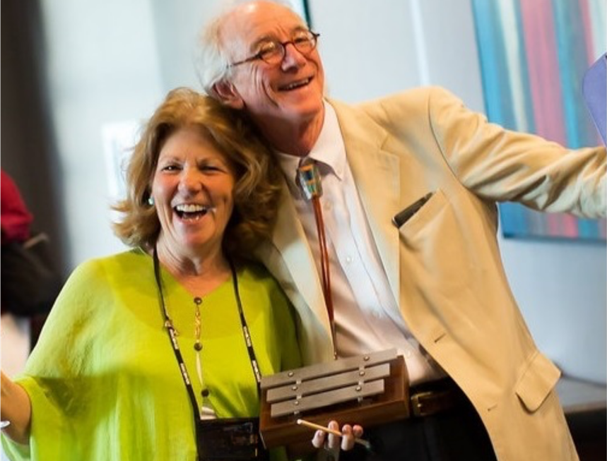 Smiling older couple holding wooden percussion instrument