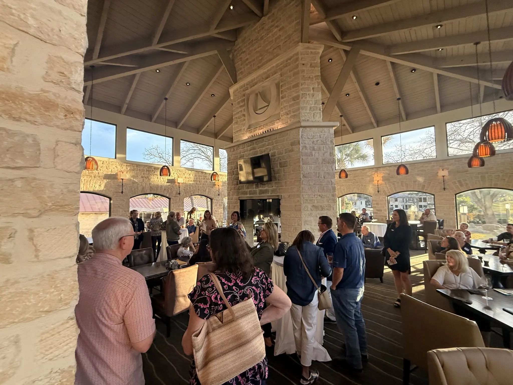 People gathered inside large stone-walled restaurant