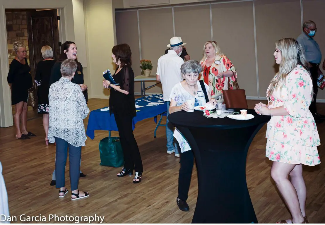 People mingling at indoor social event