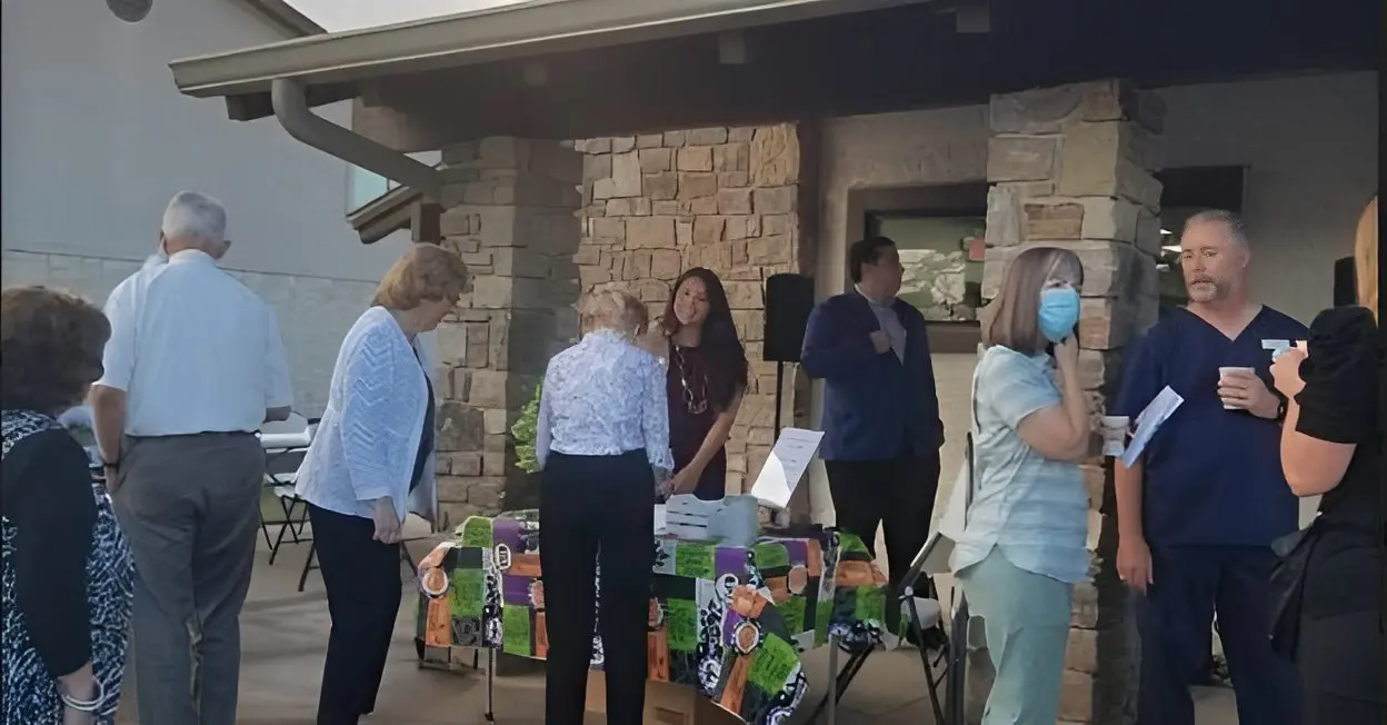 Outdoor community event with people at table