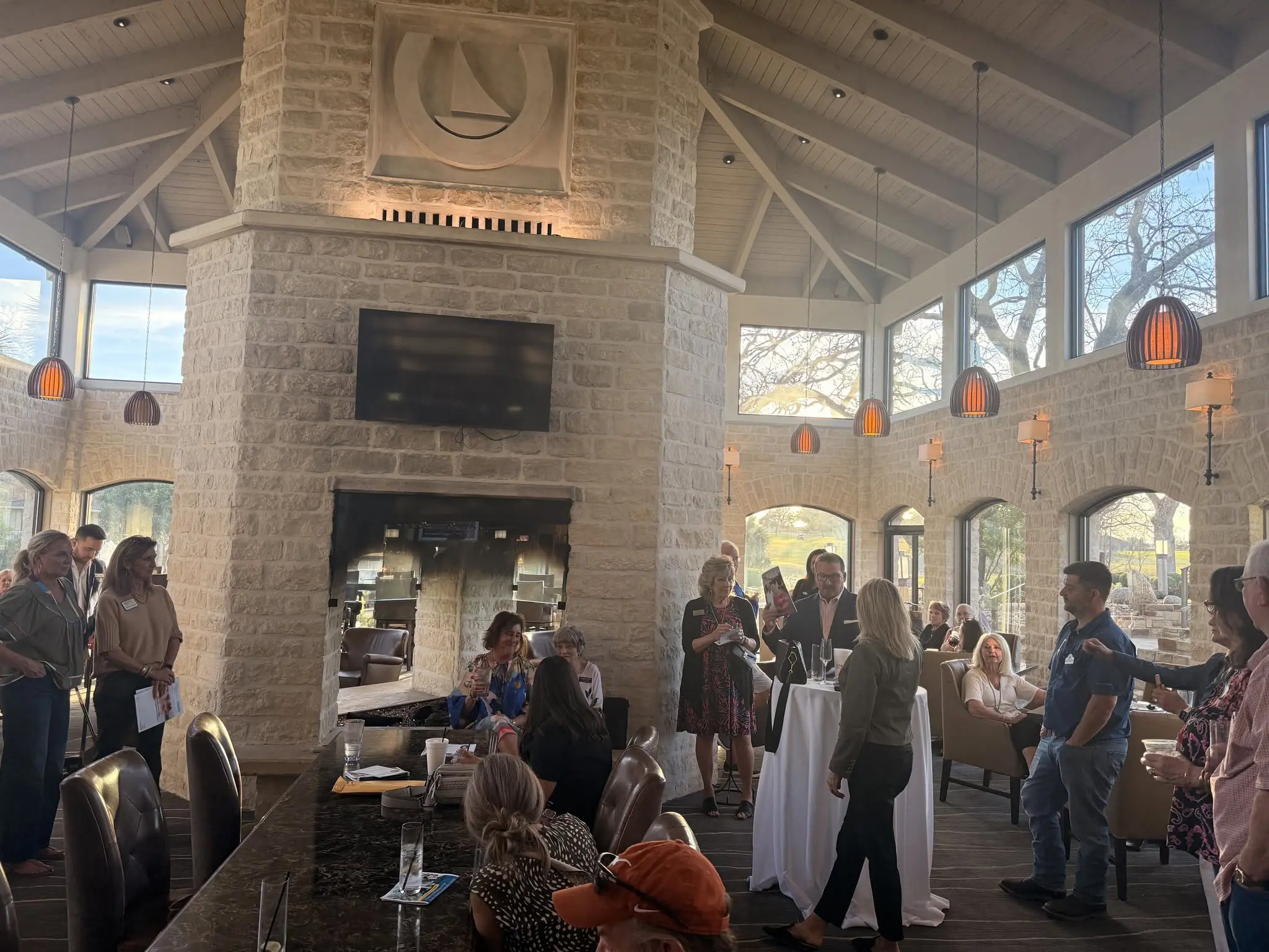 People mingling in bright stone event room
